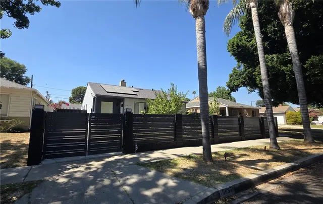 a view of a house with wooden fence
