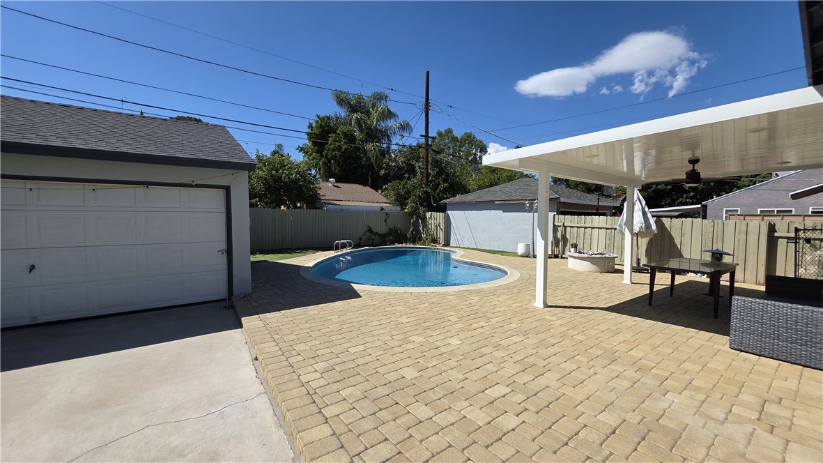 6637 Capps Avenue Reseda, CA 91335 - Photo 21 of 23 a view of a backyard with a table and chair with wooden floor