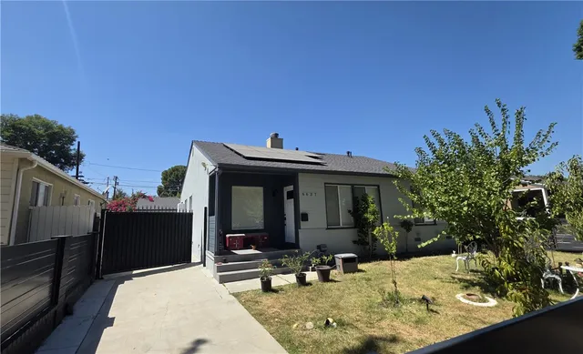 a view of a house with backyard and sitting area