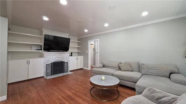 a living room with furniture a fireplace and a flat screen tv