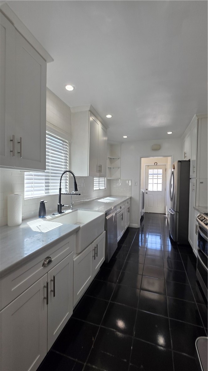 6637 Capps Avenue Reseda, CA 91335 - Photo 10 of 23 a large kitchen with stainless steel appliances a large counter top