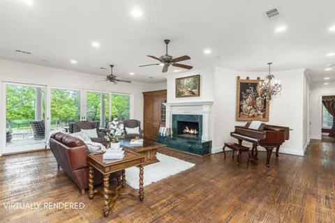 a living room with furniture a fireplace and a table