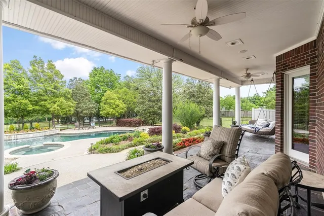 a living room with patio furniture and a potted plants