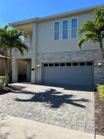 a house with palm tree in front of it