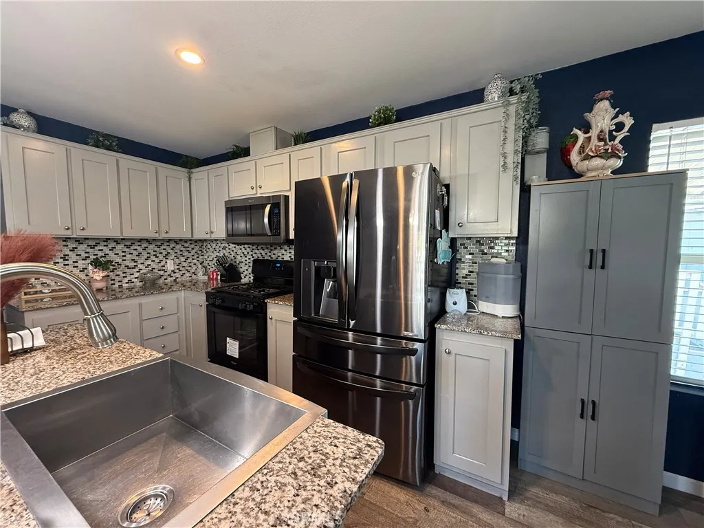 12700 Elliott, Unit 10 El Monte, CA 91732 - Photo 11 of 30 a kitchen with granite countertop a refrigerator and a sink