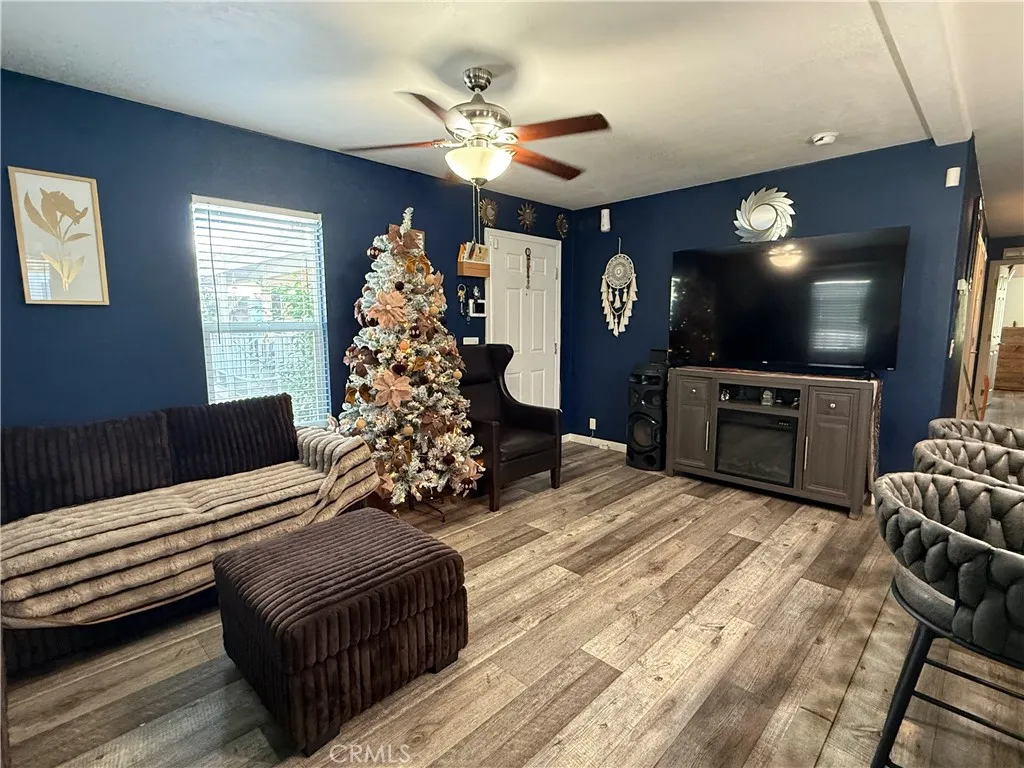 12700 Elliott, Unit 10 El Monte, CA 91732 - Photo 13 of 30 a living room with furniture a flat screen tv and a chandelier