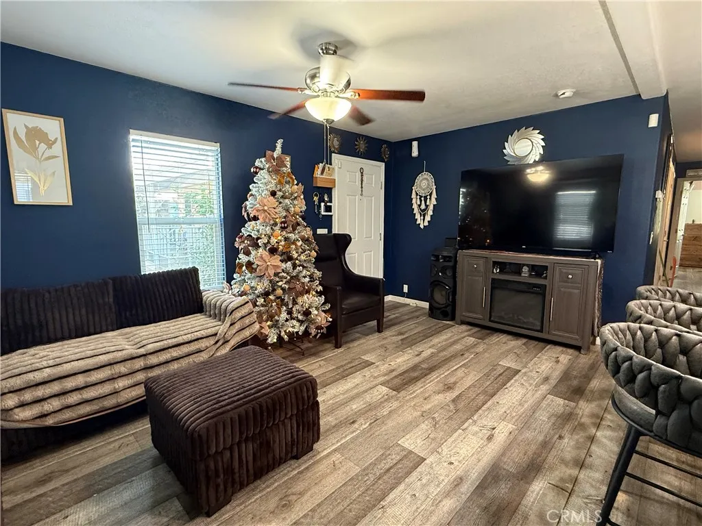 12700 Elliott, Unit 10 El Monte, CA 91732 - Photo 14 of 30 a living room with furniture a flat screen tv and a chandelier