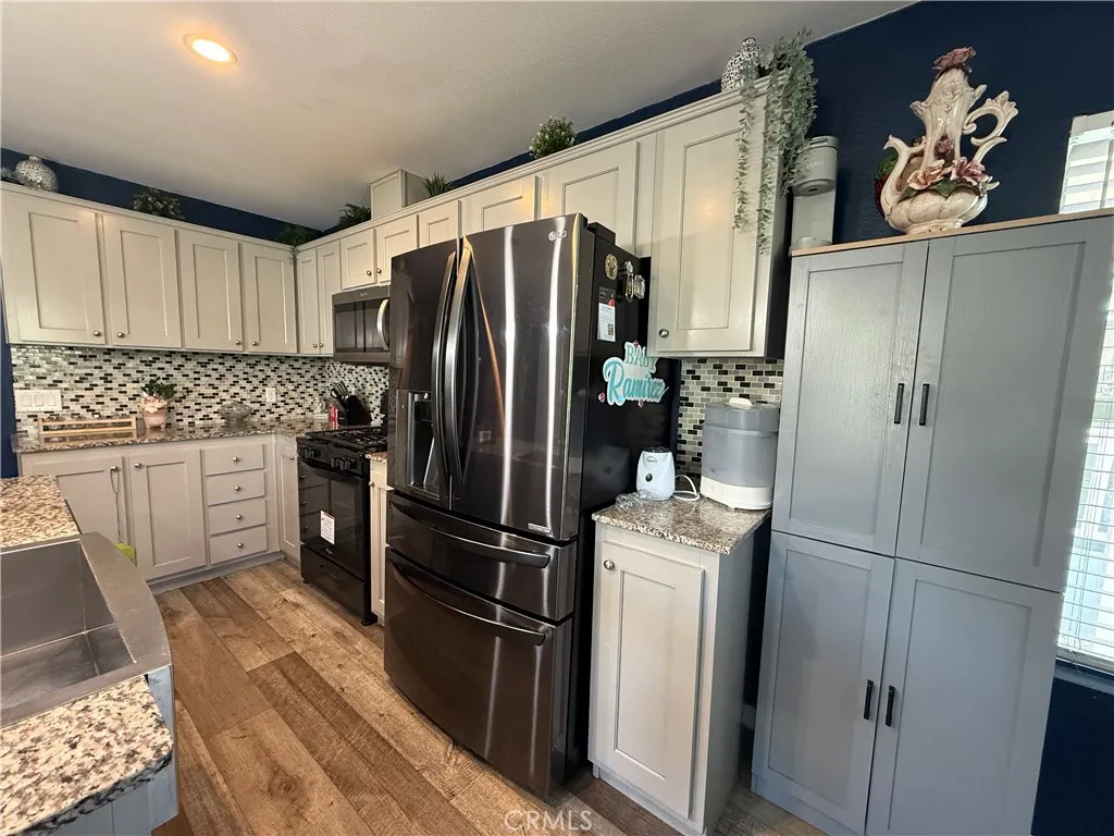 12700 Elliott, Unit 10 El Monte, CA 91732 - Photo 15 of 30 a kitchen with stainless steel appliances a refrigerator and a sink