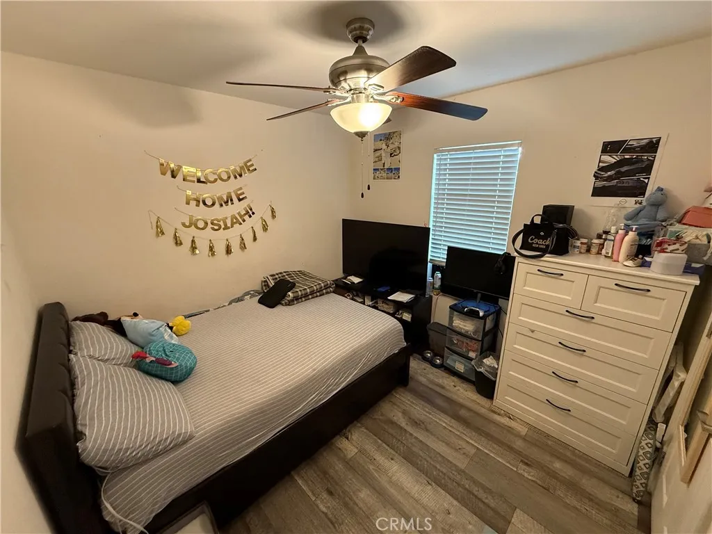 12700 Elliott, Unit 10 El Monte, CA 91732 - Photo 18 of 30 a bedroom with a bed and a chandelier