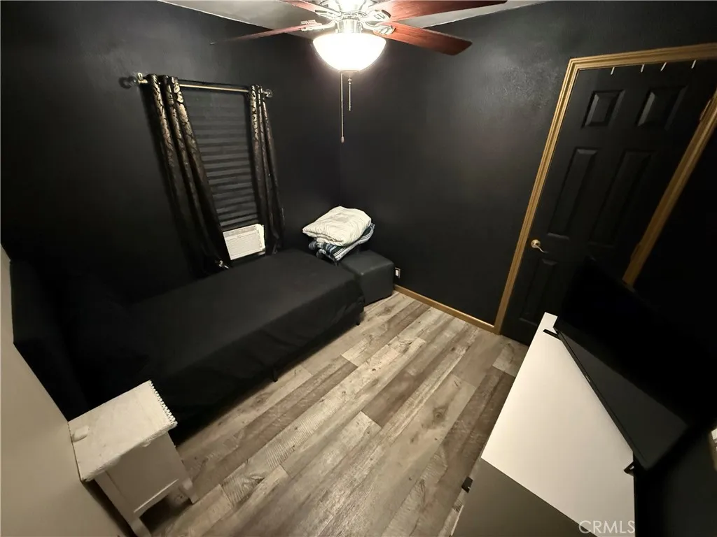 12700 Elliott, Unit 10 El Monte, CA 91732 - Photo 20 of 30 a bedroom with a bed and a chandelier