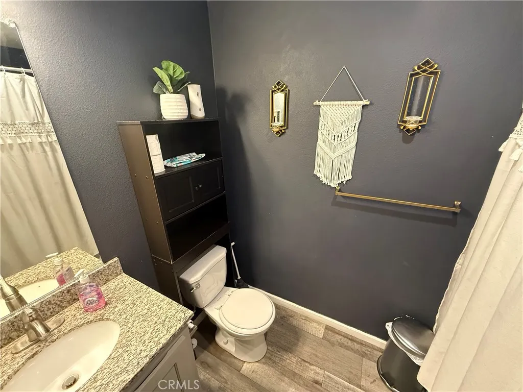 12700 Elliott, Unit 10 El Monte, CA 91732 - Photo 23 of 30 a bathroom with a granite countertop toilet and a sink