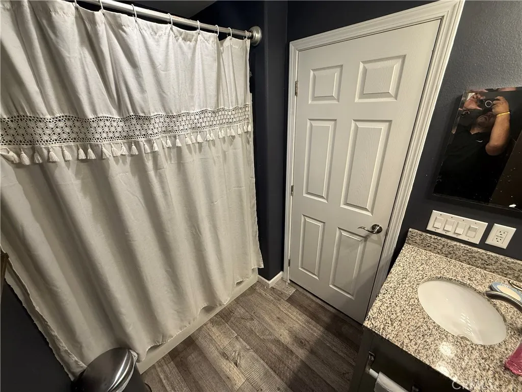12700 Elliott, Unit 10 El Monte, CA 91732 - Photo 24 of 30 a bathroom with a granite countertop sink and a mirror