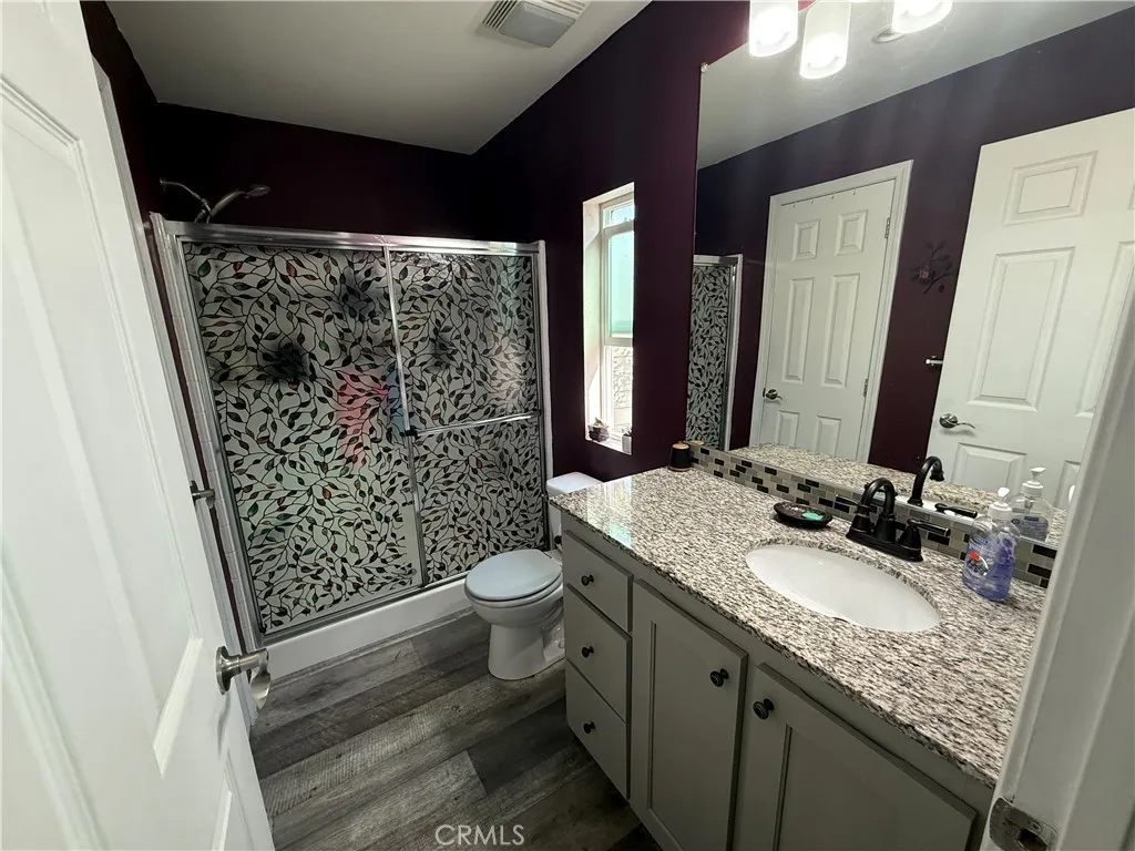 12700 Elliott, Unit 10 El Monte, CA 91732 - Photo 29 of 30 a bathroom with a granite countertop sink toilet and shower
