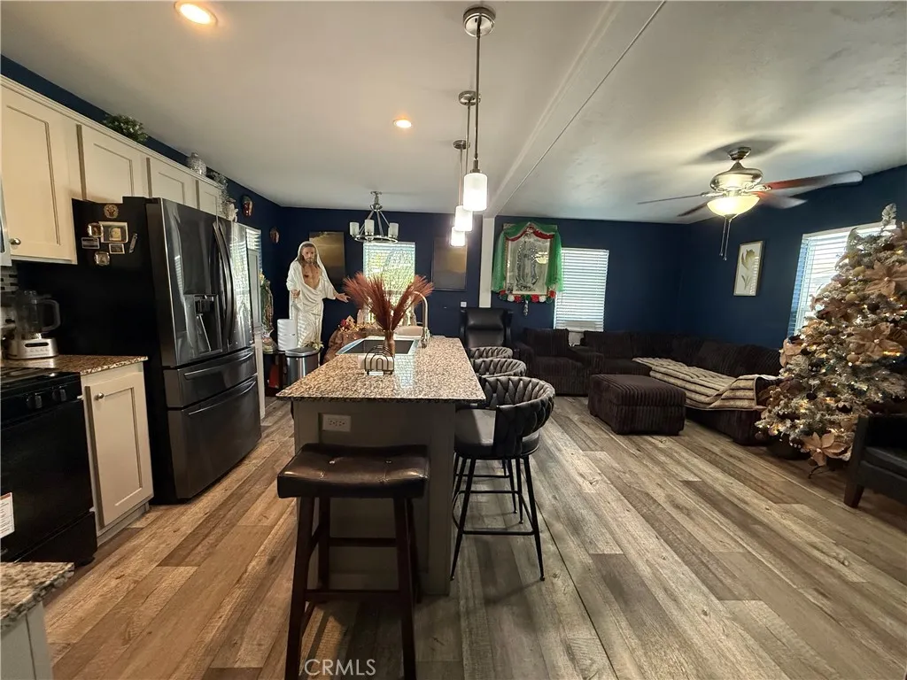 12700 Elliott, Unit 10 El Monte, CA 91732 - Photo 6 of 30 a view of a dining room with furniture a chandelier and wooden floor