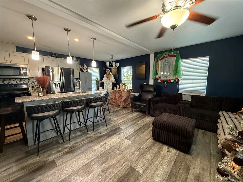 12700 Elliott, Unit 10 El Monte, CA 91732 - Photo 8 of 30 a living room with furniture a large window and a flat screen tv