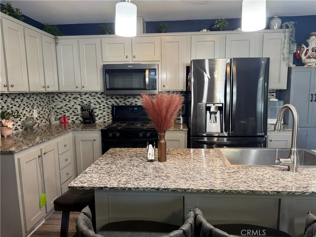 12700 Elliott, Unit 10 El Monte, CA 91732 - Photo 9 of 30 a kitchen with granite countertop a sink refrigerator and cabinets