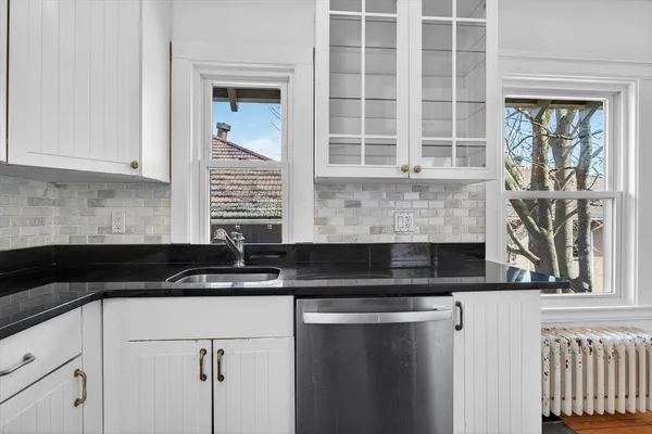 a kitchen with granite countertop a stove a sink and a granite counter tops