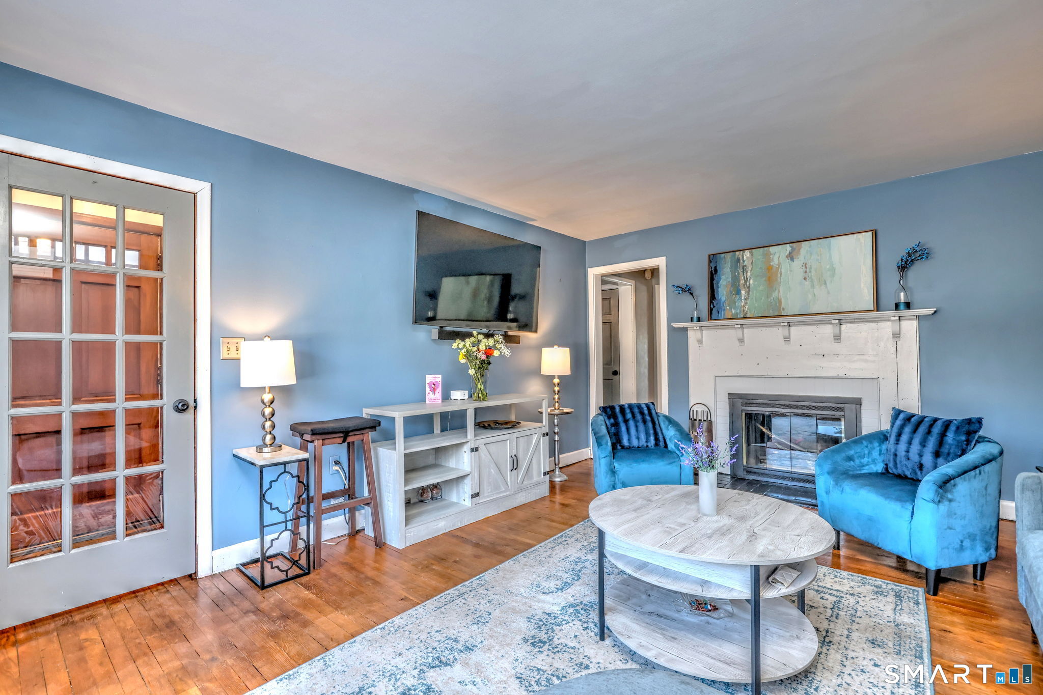 7 East Lake Road Trumbull, CT 06611 - Photo 14 of 42 a living room with furniture a flat screen tv and a fireplace