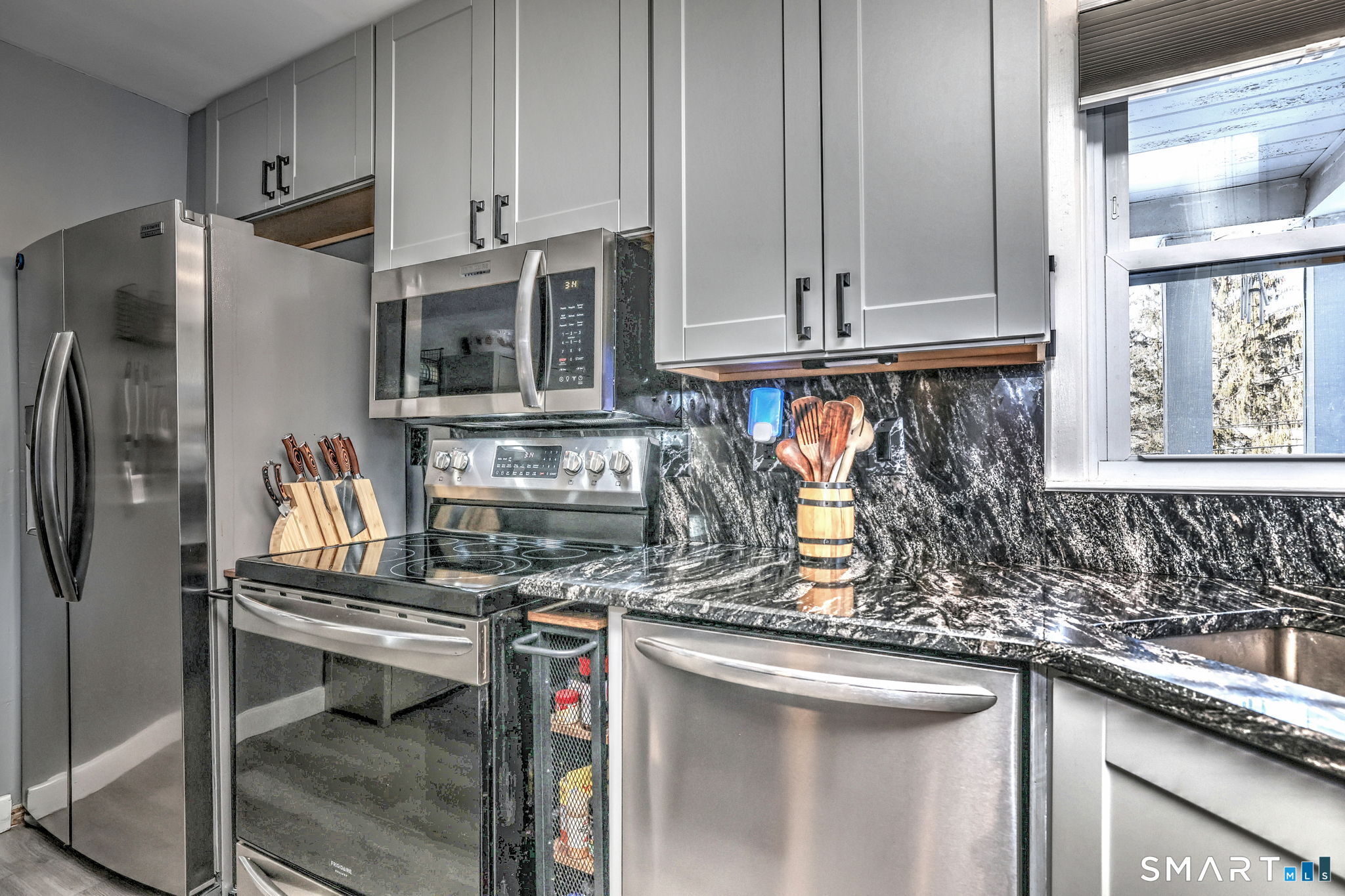 7 East Lake Road Trumbull, CT 06611 - Photo 18 of 42 a kitchen with stainless steel appliances granite countertop a sink stove and refrigerator