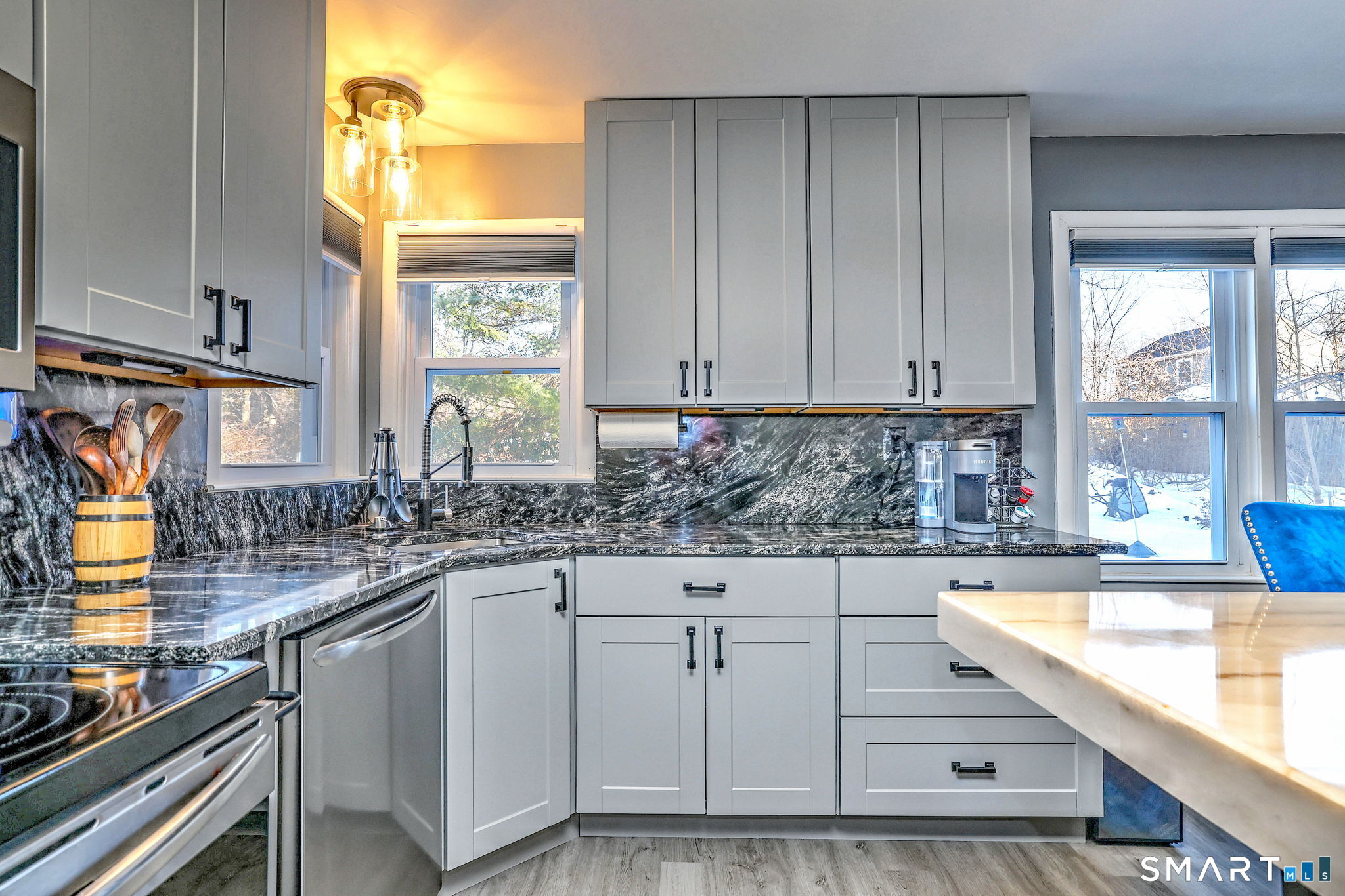 7 East Lake Road Trumbull, CT 06611 - Photo 20 of 42 a kitchen with granite countertop a sink and white cabinets