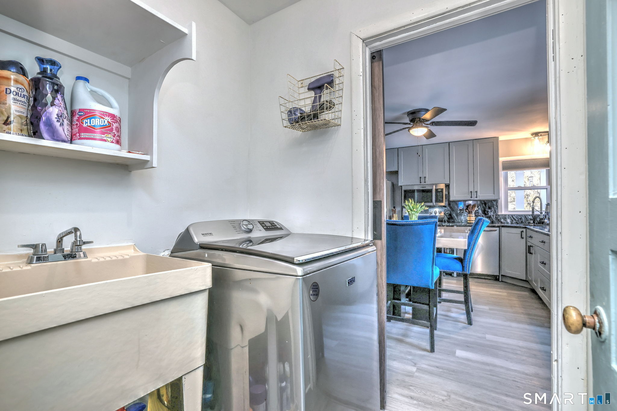 7 East Lake Road Trumbull, CT 06611 - Photo 23 of 42 a kitchen with a stove a refrigerator and a dining table with wooden floor
