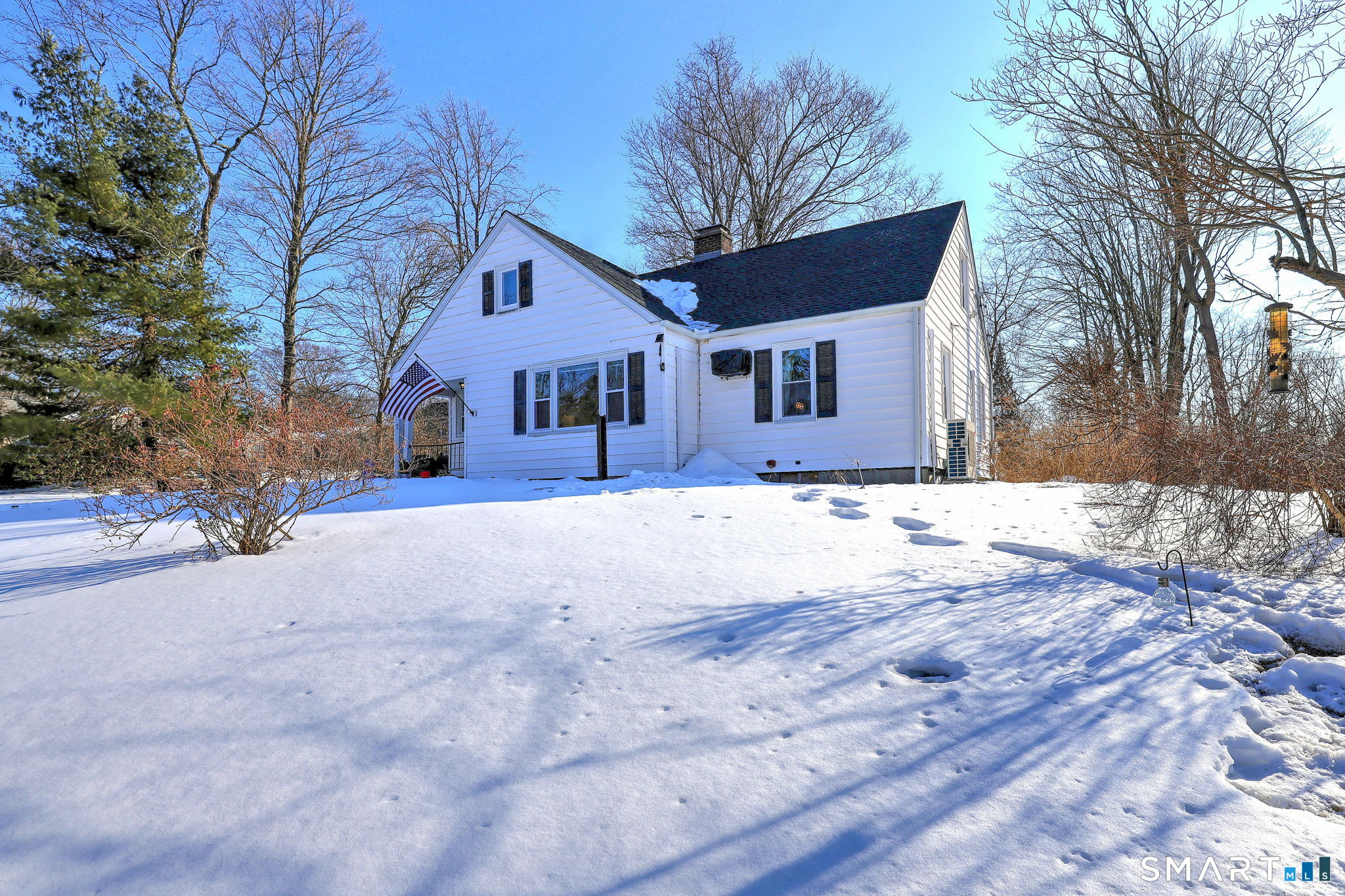 7 East Lake Road Trumbull, CT 06611 - Photo 4 of 42 a front view of house with a yard covered with snow
