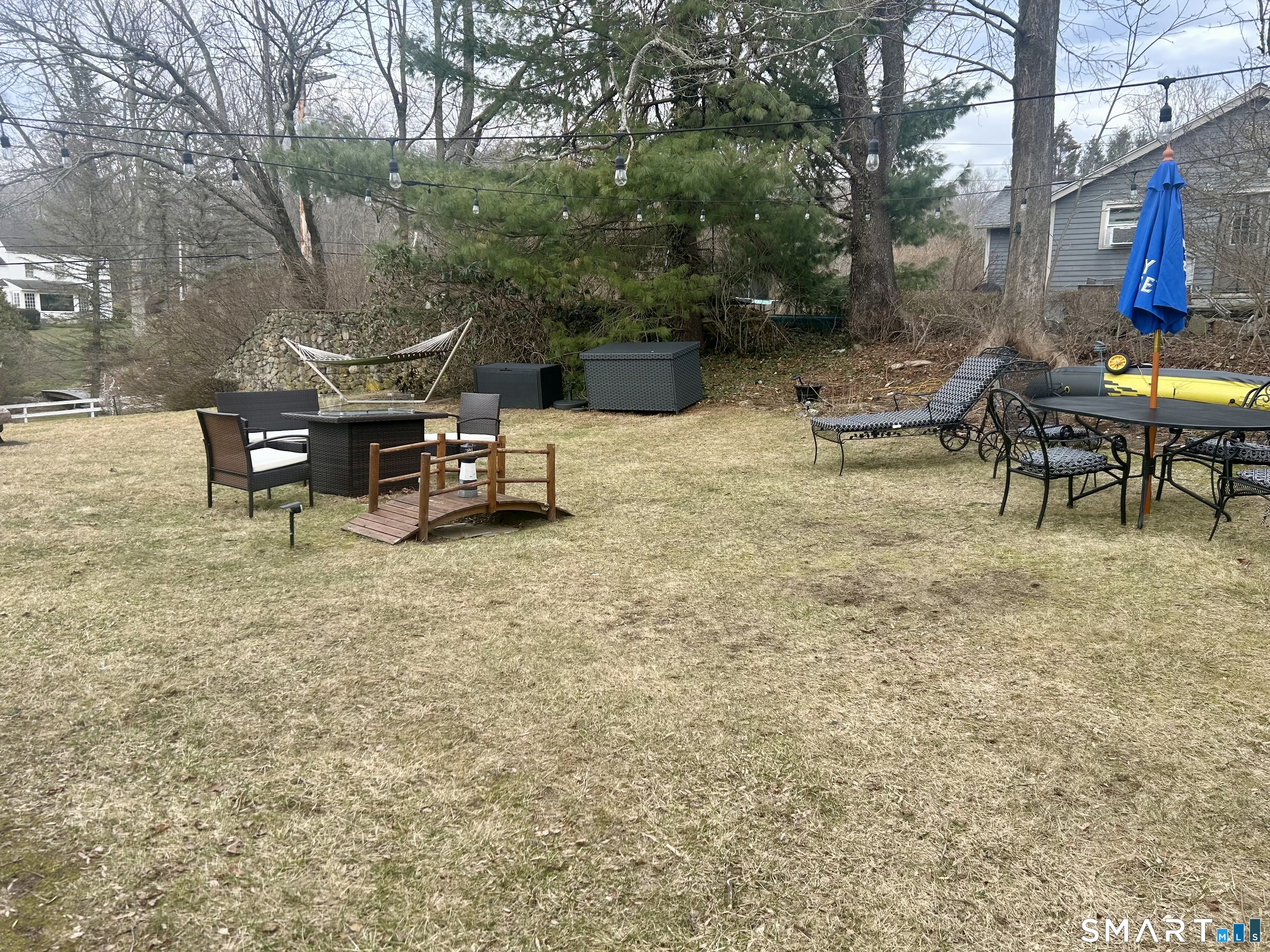 7 East Lake Road Trumbull, CT 06611 - Photo 8 of 42 a view of a backyard with table and chairs