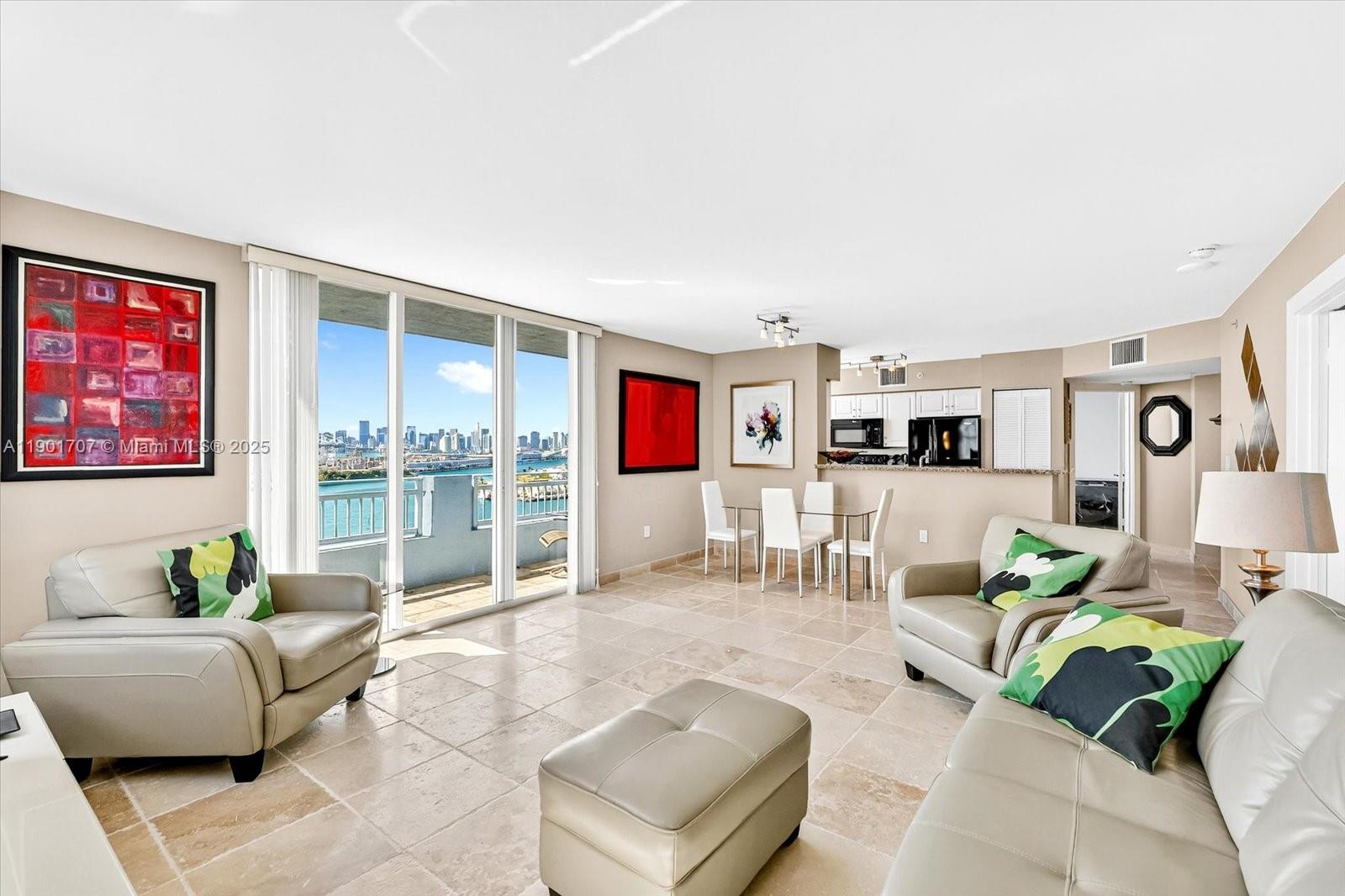 90 Alton Road, Unit 2002 Miami Beach, FL 33139 - Photo 3 of 20 a living room with furniture and a floor to ceiling window