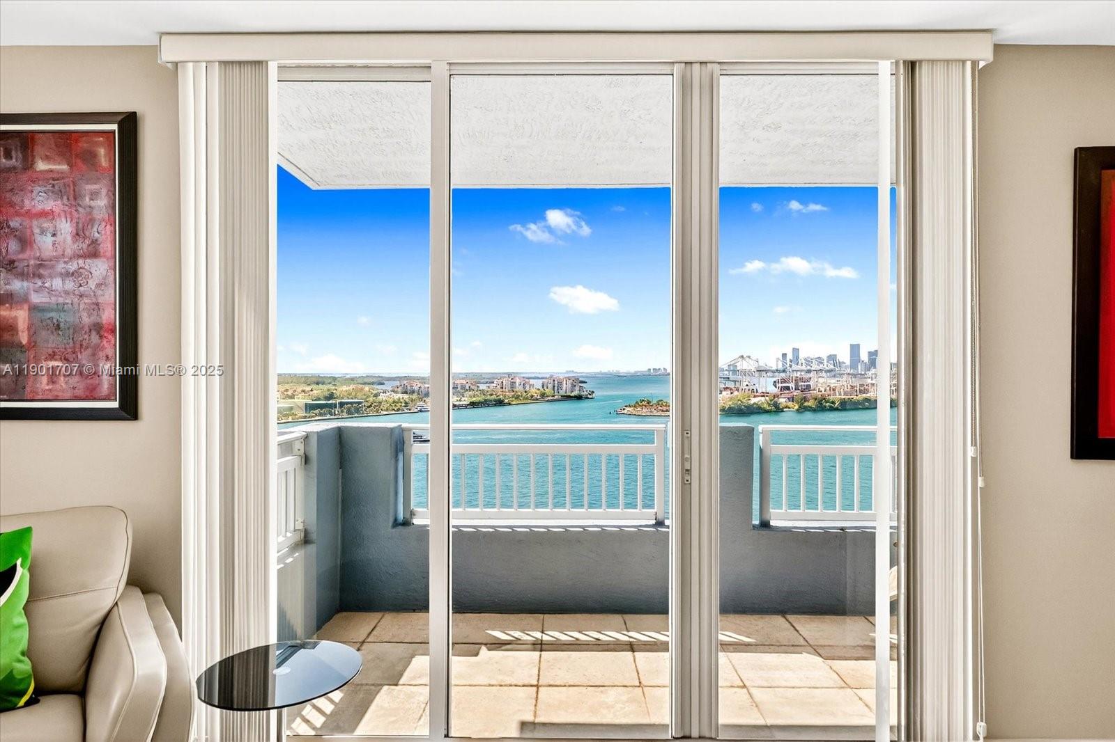 90 Alton Road, Unit 2002 Miami Beach, FL 33139 - Photo 4 of 20 a view of a living room and a floor to ceiling window