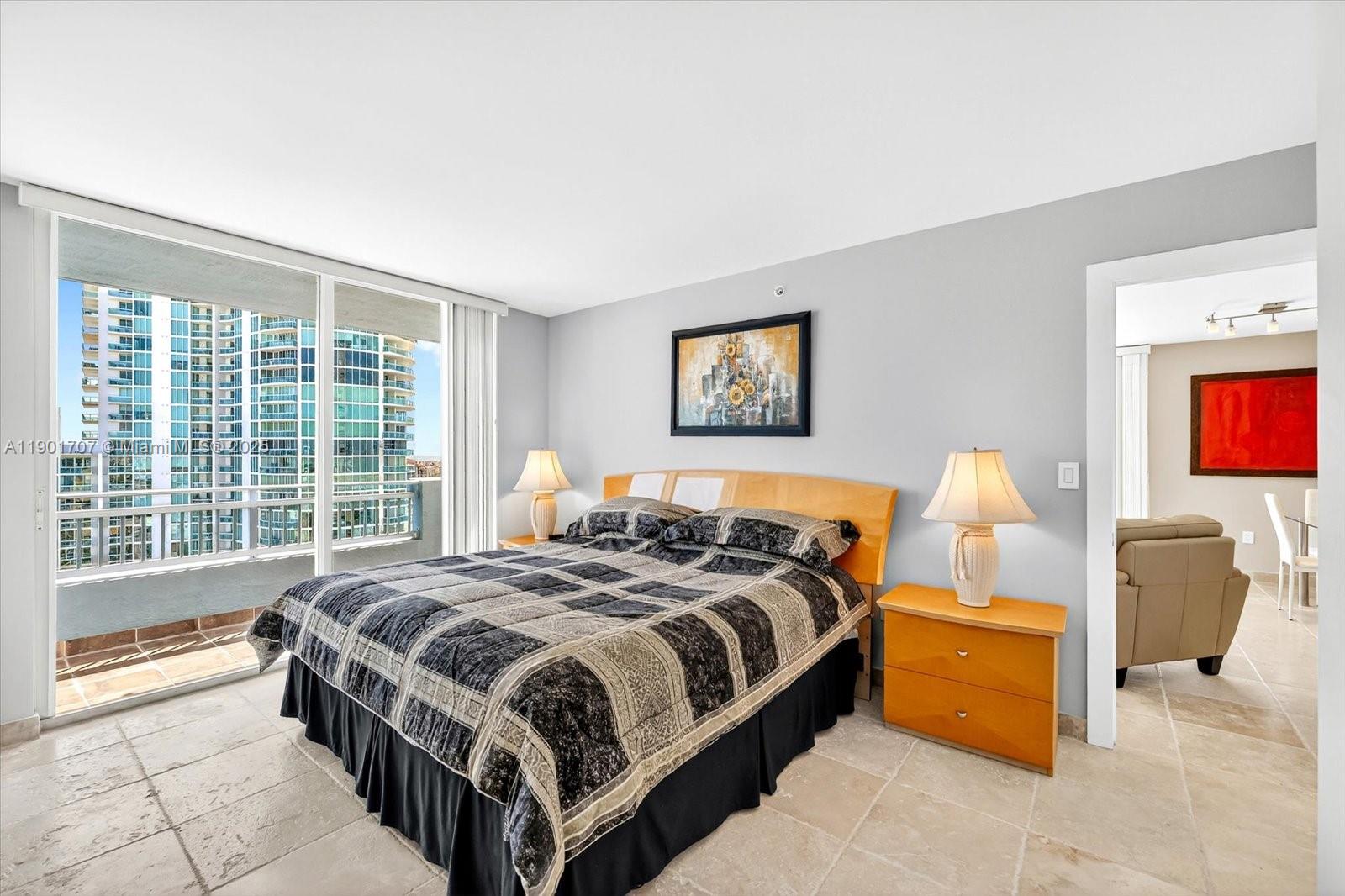 90 Alton Road, Unit 2002 Miami Beach, FL 33139 - Photo 6 of 20 a bedroom with a bed and a couch