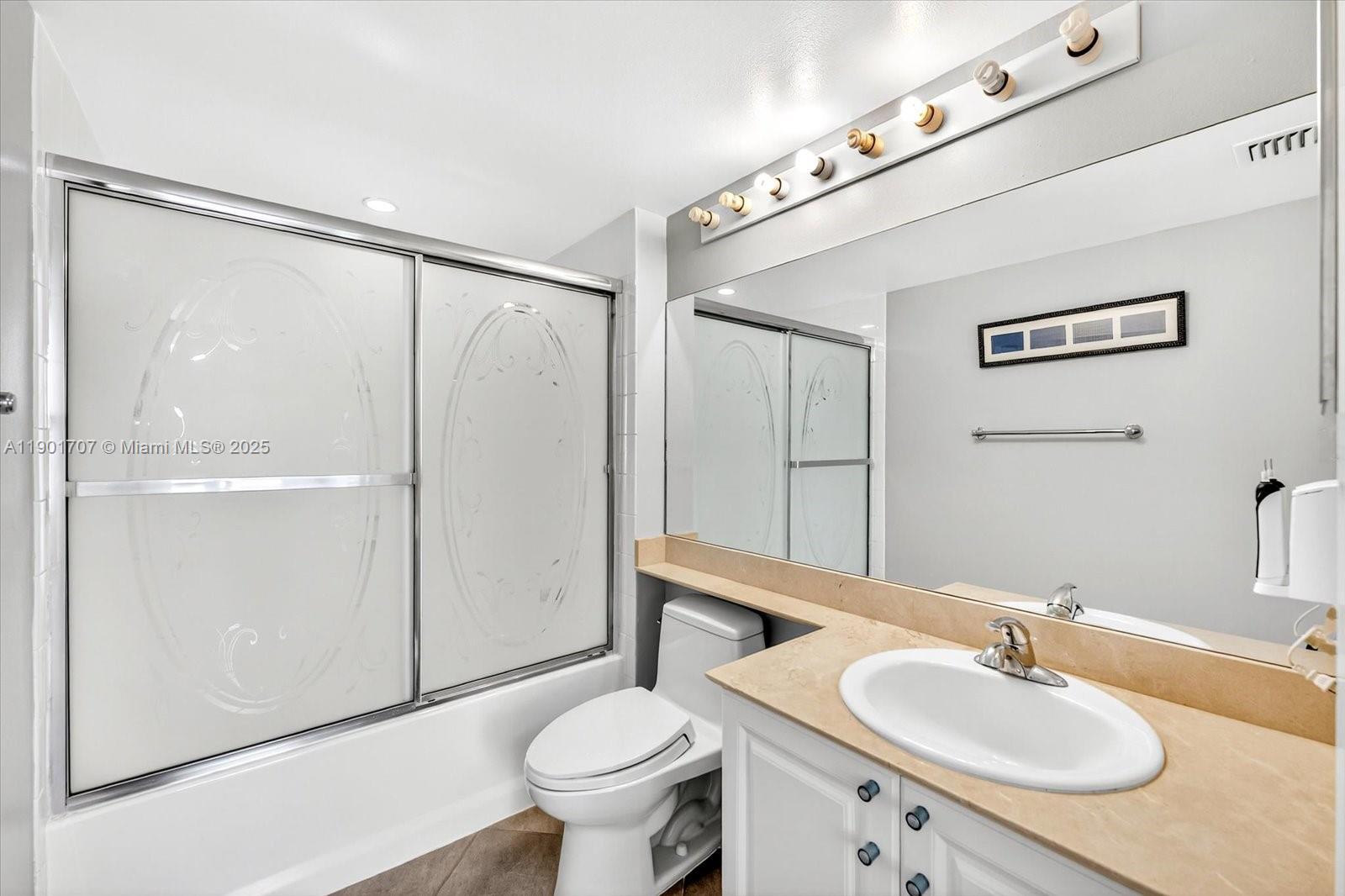 90 Alton Road, Unit 2002 Miami Beach, FL 33139 - Photo 7 of 20 a bathroom with a sink toilet and shower