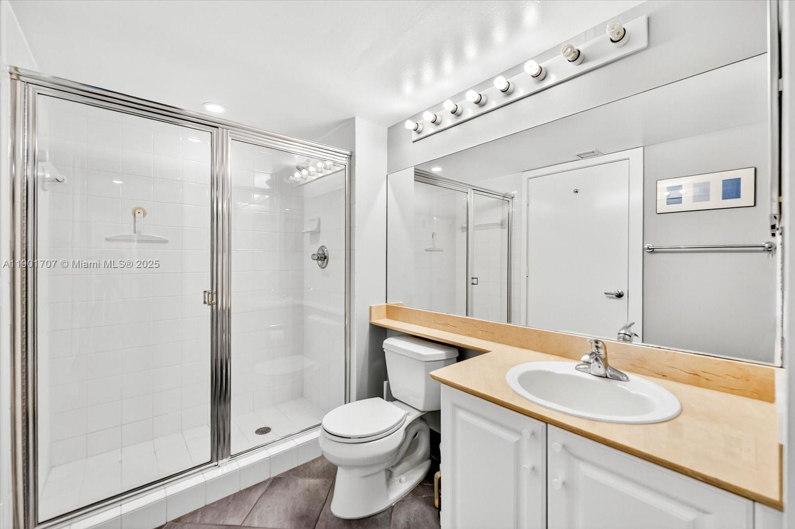 90 Alton Road, Unit 2002 Miami Beach, FL 33139 - Photo 9 of 20 a bathroom with a sink a toilet and shower