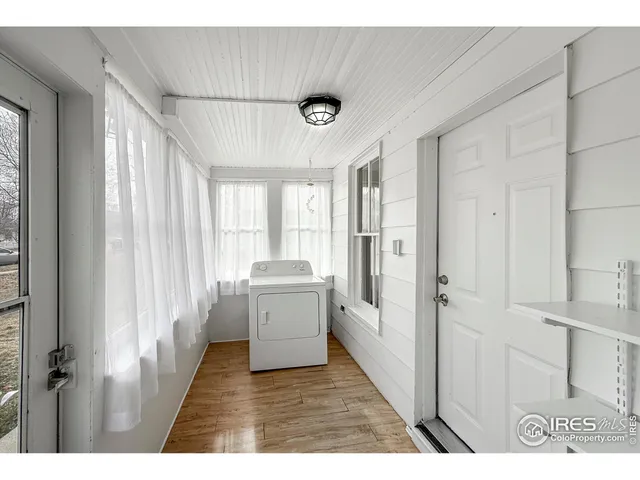 a kitchen with a refrigerator a sink dishwasher with a dining table and chairs