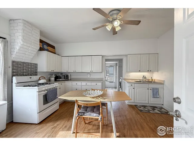 a kitchen with a stove a refrigerator and a sink