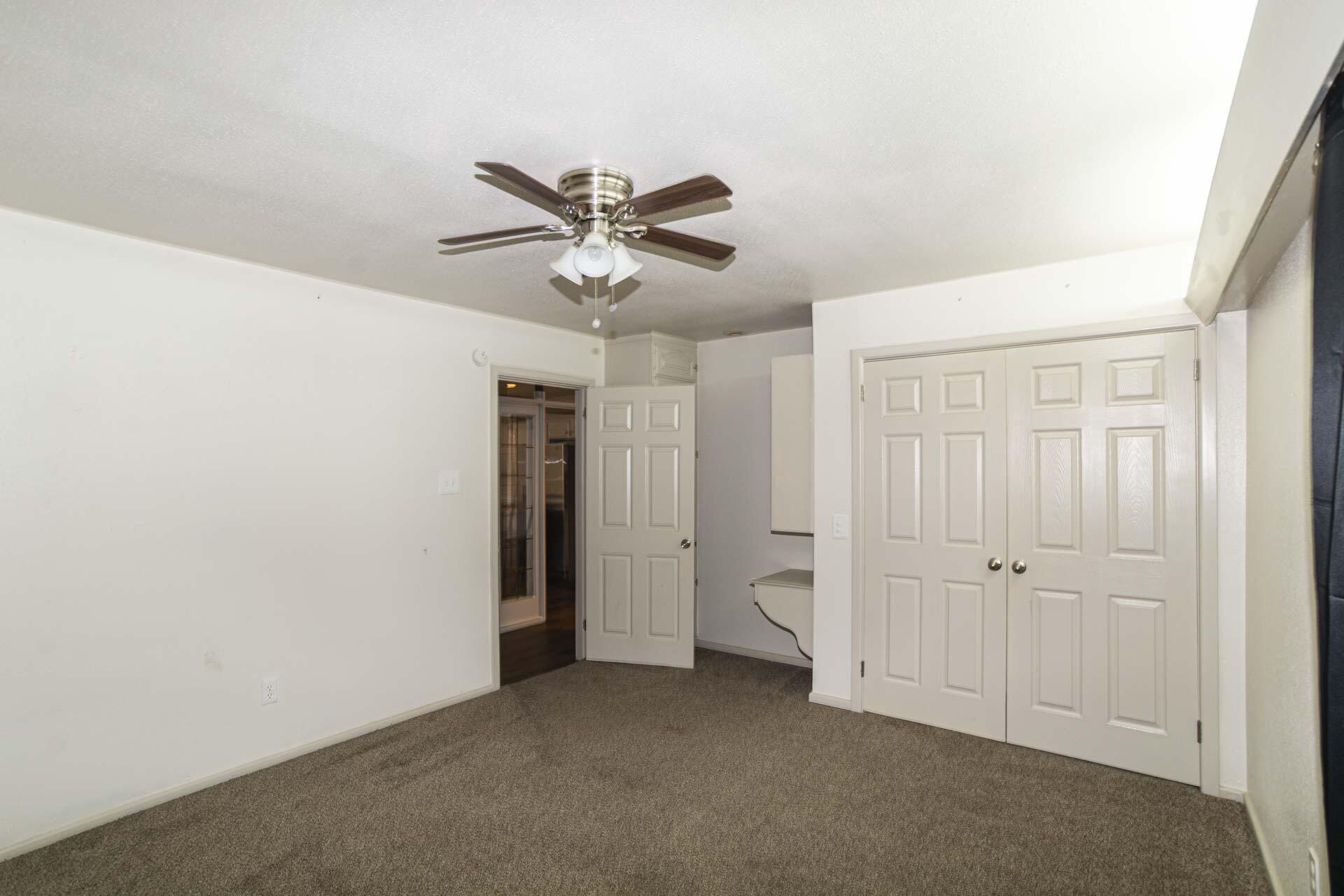 2136 57th Street Lubbock, TX 79412 - Photo 24 of 41 an empty room with a ceiling fan and a window
