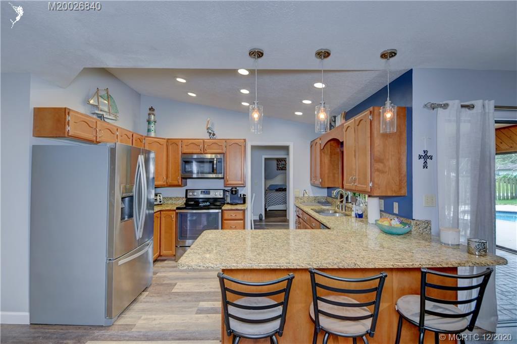 1654 Southwest 85th Terrace Stuart, FL 34997 - Photo 12 of 48 Kitchen with granite counters and SS appliances