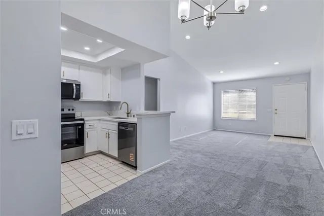 a metallic refrigerator freezer sitting in a kitchen
