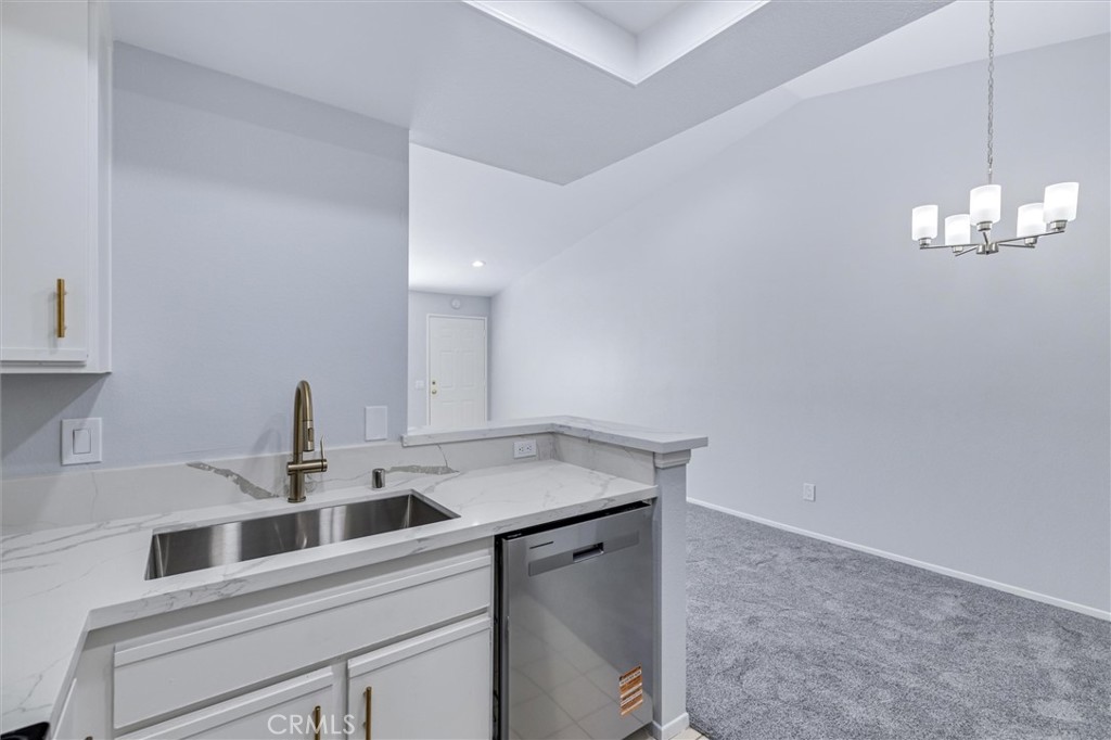 78 Costero Aisle, Unit 301 Irvine, CA 92614 - Photo 18 of 38 a kitchen with a sink cabinets and window