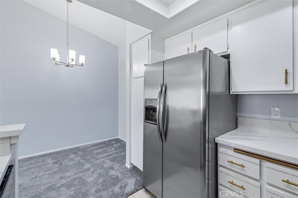 78 Costero Aisle, Unit 301 Irvine, CA 92614 - Photo 19 of 38 a metallic refrigerator freezer sitting in a kitchen