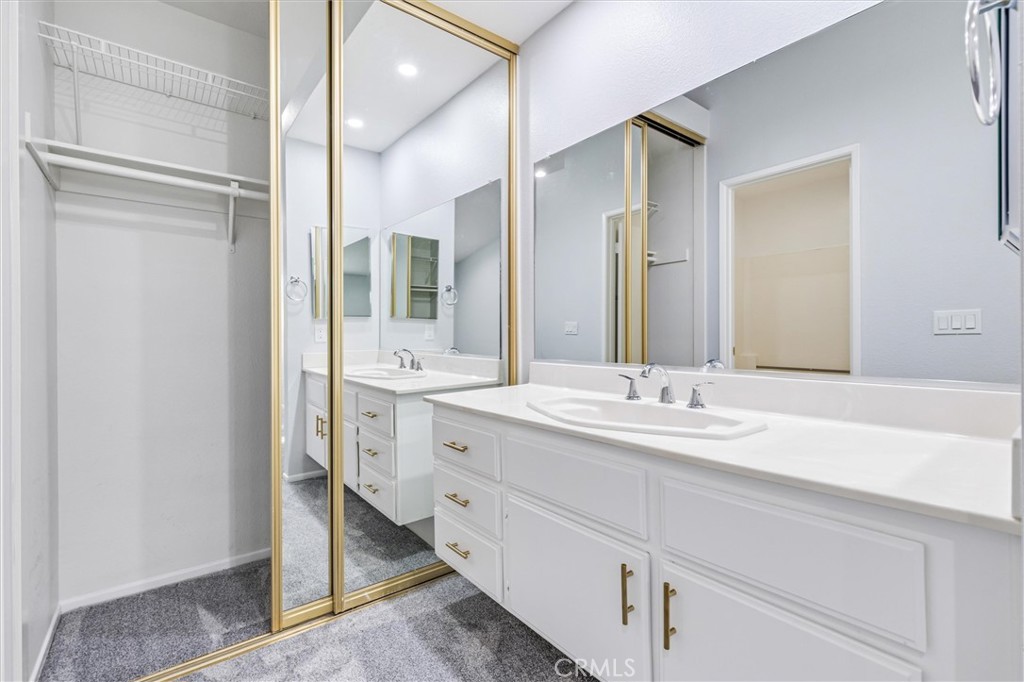 78 Costero Aisle, Unit 301 Irvine, CA 92614 - Photo 23 of 38 a bathroom with a double vanity sink mirror and double