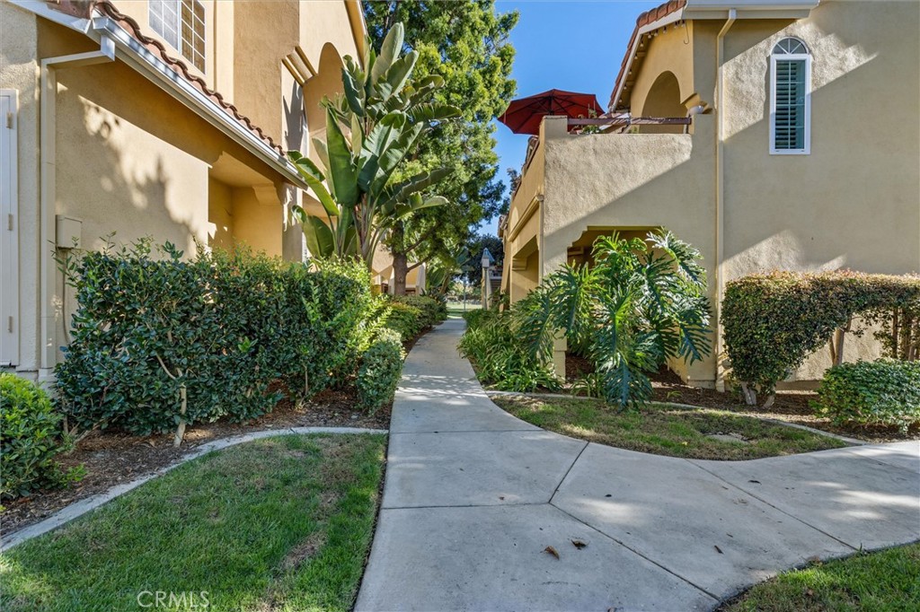 78 Costero Aisle, Unit 301 Irvine, CA 92614 - Photo 3 of 38 a view of a pathway with a fountain