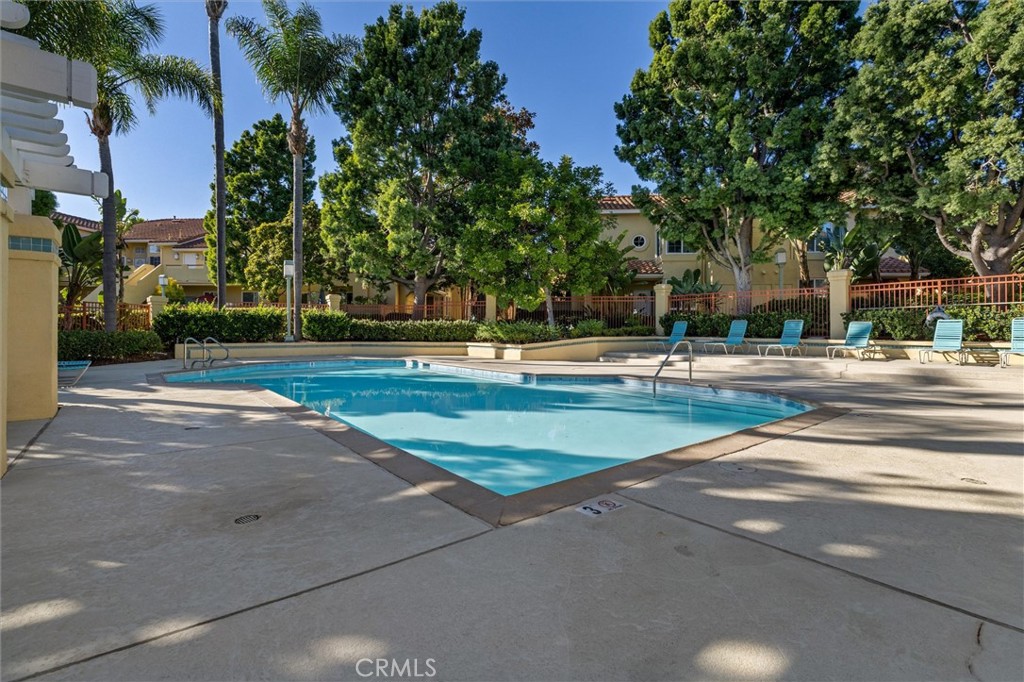 78 Costero Aisle, Unit 301 Irvine, CA 92614 - Photo 33 of 38 a view of pool and trees in the background