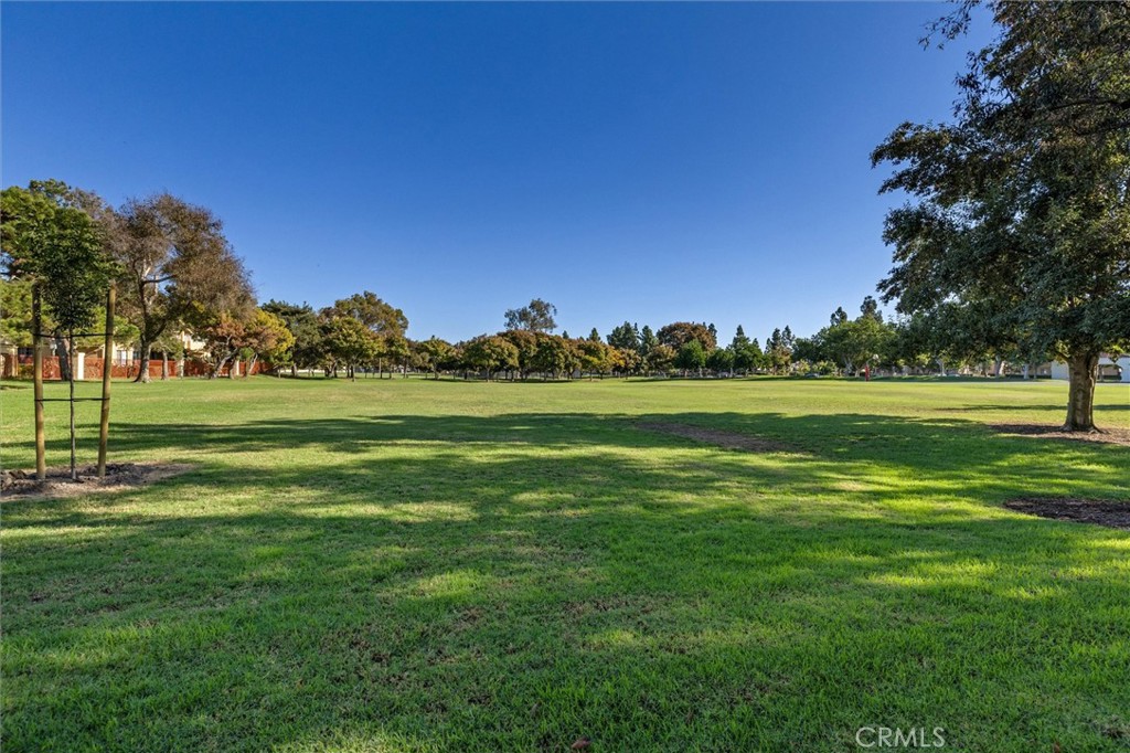 78 Costero Aisle, Unit 301 Irvine, CA 92614 - Photo 34 of 38 a grassy field with trees in the background