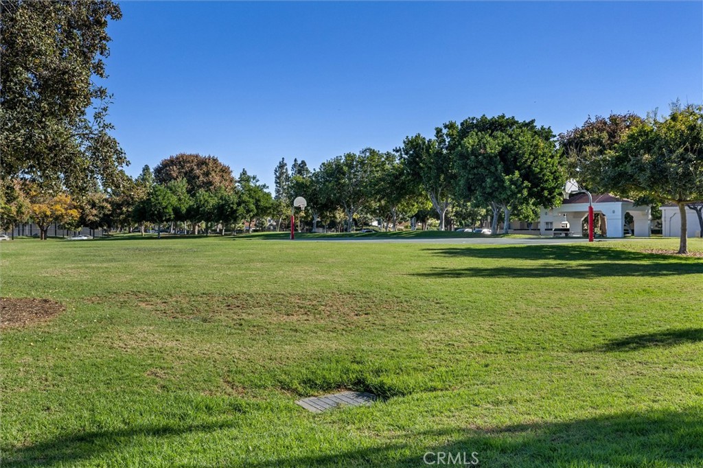 78 Costero Aisle, Unit 301 Irvine, CA 92614 - Photo 35 of 38 a view of a grassy field with trees