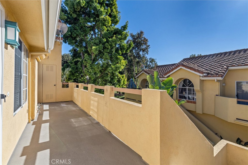 78 Costero Aisle, Unit 301 Irvine, CA 92614 - Photo 5 of 38 a view of a white house with a large window and potted plants