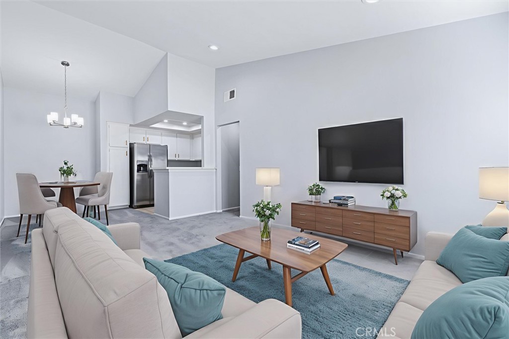 78 Costero Aisle, Unit 301 Irvine, CA 92614 - Photo 7 of 38 a living room with furniture and a flat screen tv