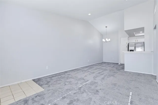 a view of empty room with a kitchen