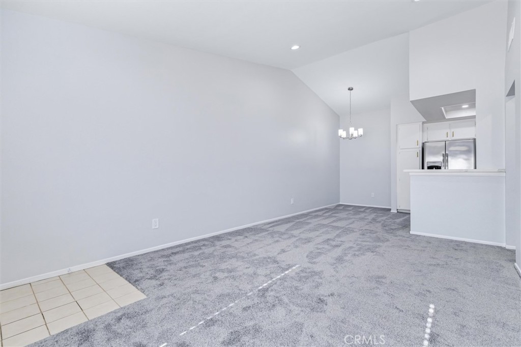 78 Costero Aisle, Unit 301 Irvine, CA 92614 - Photo 8 of 38 an empty room with windows and entrance to other room