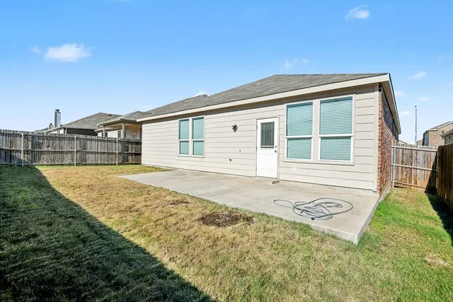 a front view of a house with a garden and yard