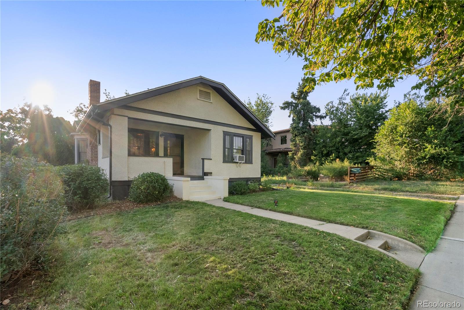 3009 Depew Street Wheat Ridge, CO 80214 - Photo 1 of 32 a front view of a house with garden